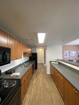 Large walk through kitchen with a microwave,stove and dishwasher!