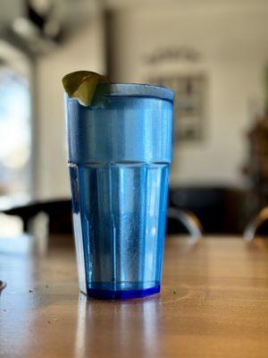 Plastic blue cup with tap water