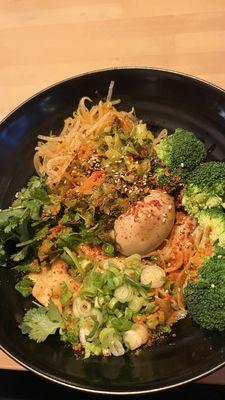 Garlic biang biang veggie noodle with pickled veggies and spiced egg.