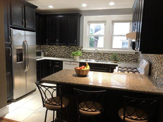 Kitchen with two refrigerators, island seating, dishwasher and microwave, at 6 Comstock Apt#2