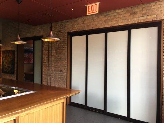 Laminated glass panels in our wenge frame finish makes a great room divider for restaurants, hotel lobby and leasing office areas.