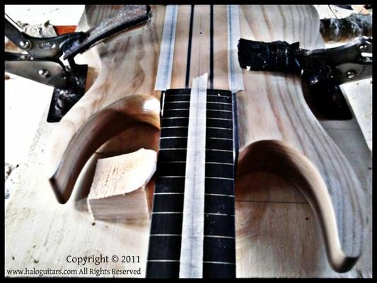 Behind the scenes: guitar being prepared for pickup and bridge routing.