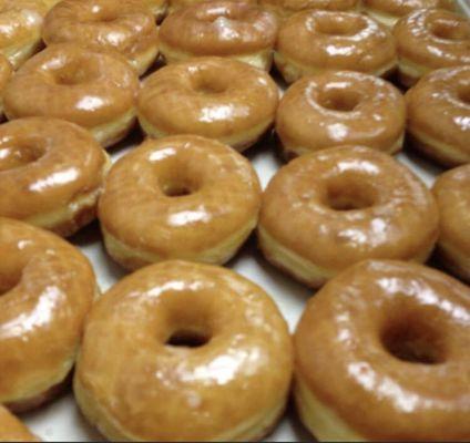 Hot and fluffy glazed donuts.