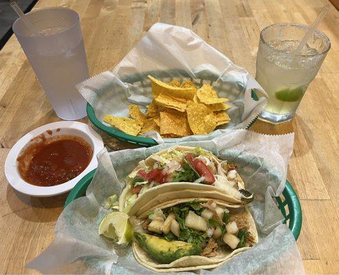 One carnitas and one shrimp taco, complimentary chips and salsa.