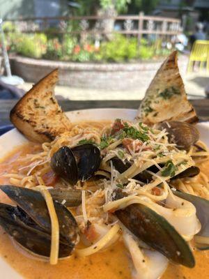 From the menu: LINGUINI FRUTTI DI MARE $24 CLAMS, GREEN & BLACK MUSSELS, CALAMARI, PRAWNS, WITH HOME MADE MARINARA SAUCE