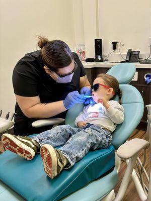 My son getting a thorough teeth brushing by the sweet dental hygienist.