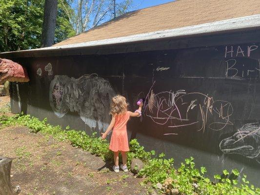 the back of the building is a giant chalkboard for kids (and adults!) to write/draw at