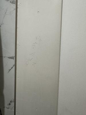 Writing on bathroom wall left over from contractors