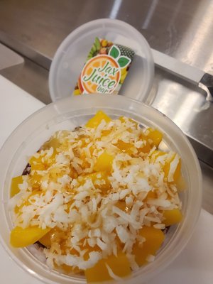 Tropical Twist Acai Bowl. Acai, Sliced Mangoes, Pineapple, Coconut shavings & Honey