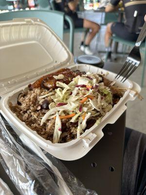 Delicious boneless Kingston jerk chicken with amazing sweet plantains, beans and rice, and a vinegar based Cole slaw.