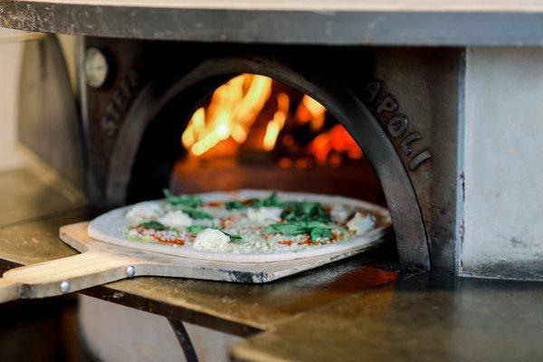 All of our pizzas are cooked to perfection in wood fired ovens which are imported from Italy.