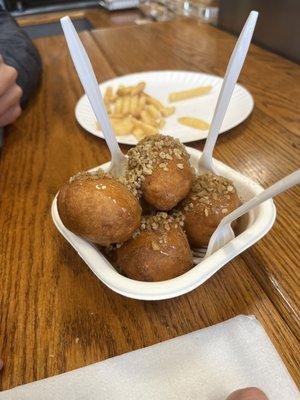 Loukoumades - Greek donuts, fried fresh and covered in honey, walnuts and cinnamon