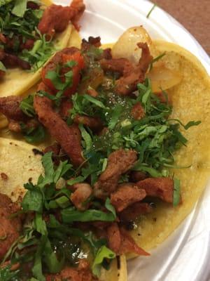 Beautiful tacos al pastor with cilantro and salsa verde