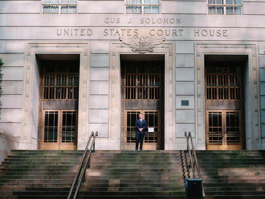 Chris Roy, Attorney and Founder of Roy Law Group, on the steps of the U.S. Court House in Portland, Oregon.