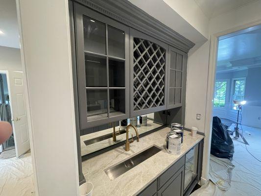 Interior Painting: Wet bar in Bernardsville, NJ that used to be Mahogany. Cleaned, sanded, primed, and painted.