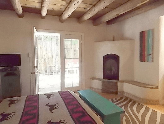 Bedroom in this Taos historic district 1920s home (renovated in 2006), opens to private courtyard -- one of 5! 304 Ortiz