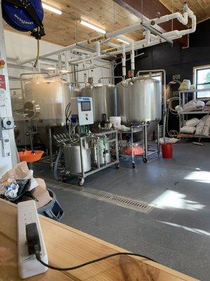 View of Brewery equipment from inside restaurant dining area.  Very cool!