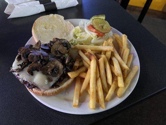 Mushroom Swiss burger with fries.