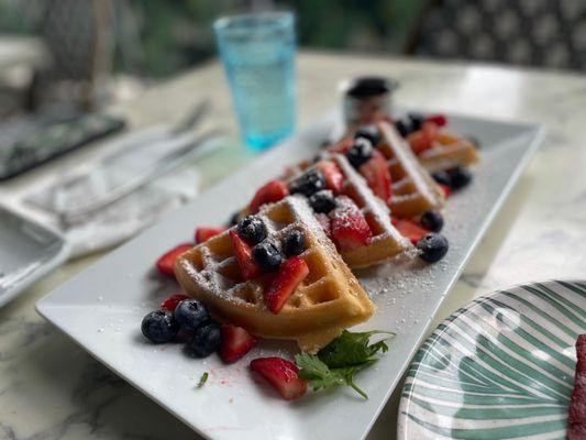 Waffles with strawberries, blueberries, & sprinkled with powdered sugar