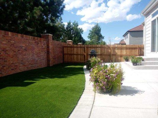 Artificial turf mixed with hardscape and fencing.