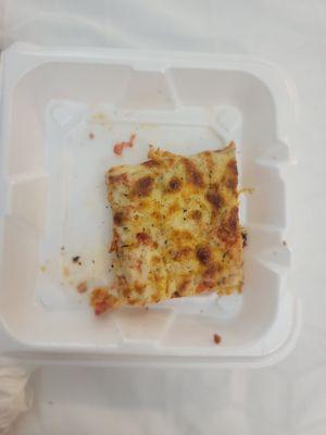 Slice of Ham pizza,  Styrofoam containers provided by restaurant since we were in a Hotel.