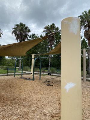 Swing set area on playground. Needs fresh paint