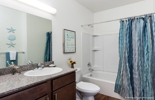 Spacious bathrooms with simulated hardwood flooring.