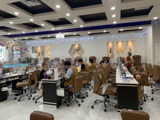 Pedicure area along side walls 10 chairs in each side 20 manicure tables in the middle