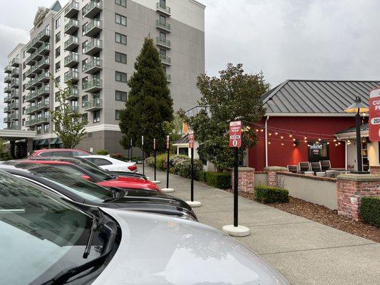 Curbside parking spaces are parked by those that dine in. Left side