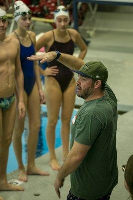 Coach working with swimmers