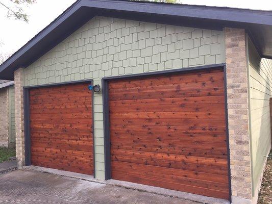 We built custom wood siding walls to create the appearance of garage doors.  Garage conversion behind.