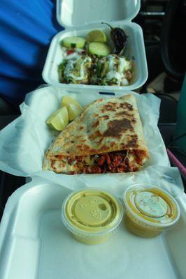 Both Tacos de asada bomba style and chicken quesadilla with guacamole sauce and salsa verde