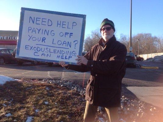 A volunteer spreading the word about Exodus Lending outside of a payday lender.