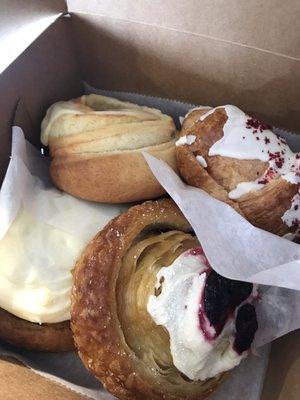 Cinnamon roll, orange roll, raspberry white chocolate croissant, and a cherry something roll.