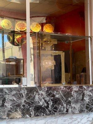 Lucite window where your food is passed to you. Reminded me of bodegas in NY