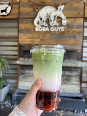 Large strawberry matcha latte with boba and light ice.