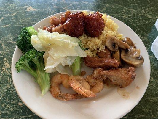 Broccoli, steamed cabbage, Kung Pao chicken, sautéed mushrooms, breaded shrimp, peanut chicken, house fried rice, and two shrimp balls