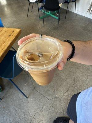 Signature cold brew -- cold brew, cardamom syrup, and a splash of oat milk