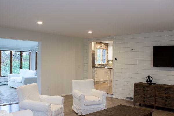 Kitchen Craft Cabinets in Alabaster, brick backsplash, concrete countertops and a solid pine table top on the island