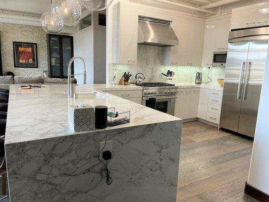 Kitchen Remodel in downtown loft with high gloss doors and Dekton countertop with waterfall edge