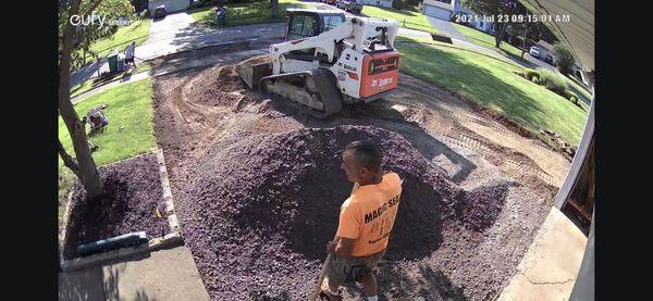 Leveling and adding crushed stone for drainage before compacting.