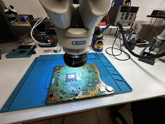 PlayStation 5 Slim motherboard on the micro soldering desk ready for the HDMI port replacement.