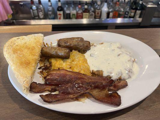 The all meat breakfast, with bacon, sausage, and country fried steak, hash browns and sourdough toast