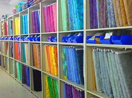 eQuilter Warehouse shelves filled with a rainbow of colors and patterns.