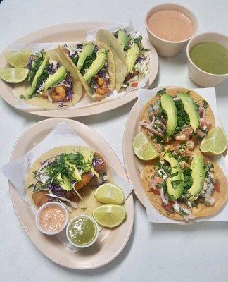 Fried fish taco, grilled shrimp tacos and Vuelve a la Vida tostadas served with green salsa and chipotle spicy salsa.