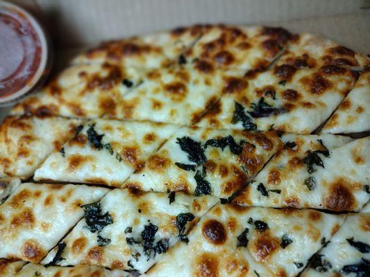 Garlic chips: pizza crust covered with olive oil, minced garlic, mozzarella, basil and fresh pesto