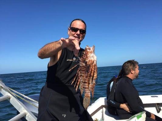 Big kahuna Jeff Dawson showing off how we do our part to help eradicate invasive lionfish. (Bonus: they're delicious!)