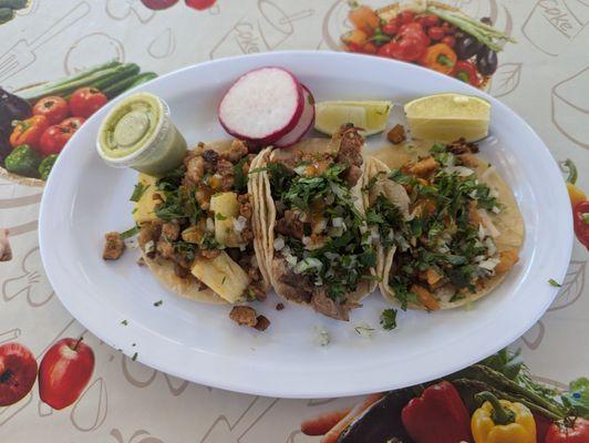 3 tacos, $9.  Adobo on the left (great), carnitas in the middle (excellent), chicken on the right (great).