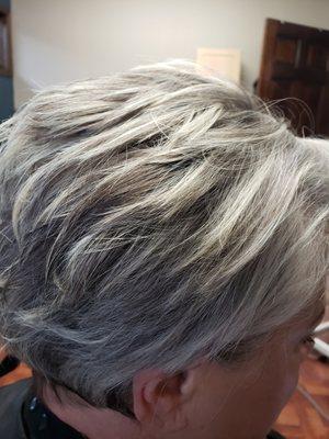 Judy looks fantastic with her natural grey hair and some blonde highlights throughout.