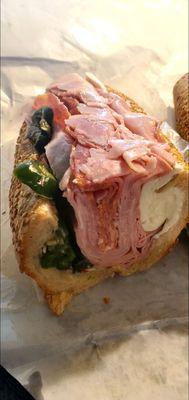 Mortadella, ham, hot soppresata, fresh mozz, hot pepper rings, on a seeded wedge.